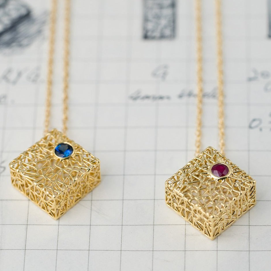 Gold box pendant with ruby